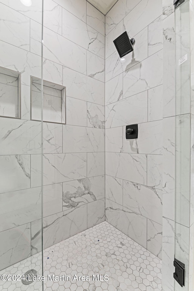 bathroom with a shower with shower door