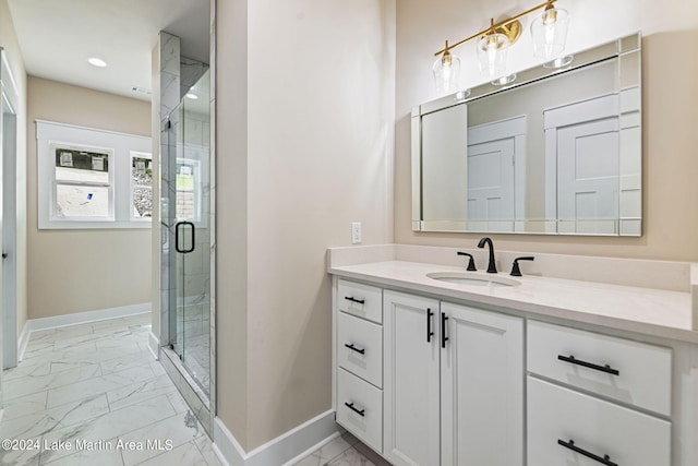 bathroom featuring vanity and a shower with shower door