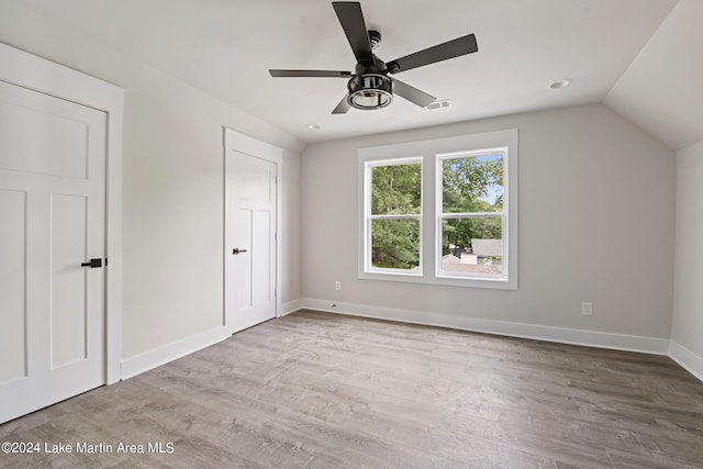 unfurnished bedroom with vaulted ceiling, light hardwood / wood-style flooring, and ceiling fan