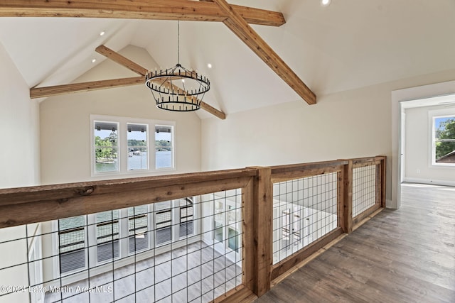 corridor with beam ceiling, high vaulted ceiling, hardwood / wood-style flooring, and an inviting chandelier