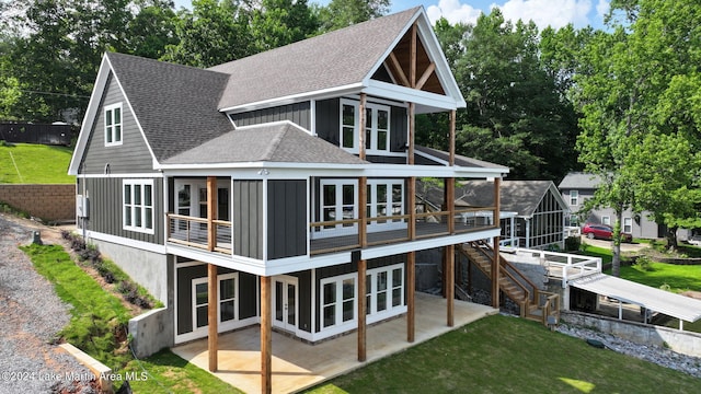 back of property featuring a lawn, a patio area, and a deck