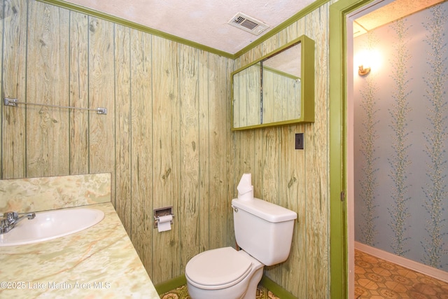 405 4th St, Tallassee, AL 36078 - bathroom with crown molding, vanity, and wallpapered walls