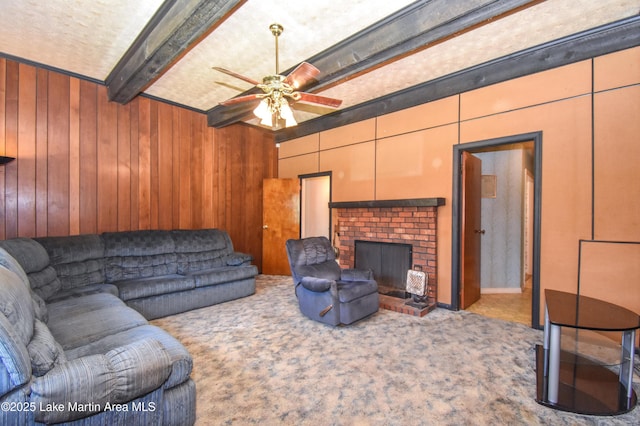 405 4th St, Tallassee, AL 36078 - living area with carpet, ceiling fan, beamed ceiling, wood walls, and a fireplace
