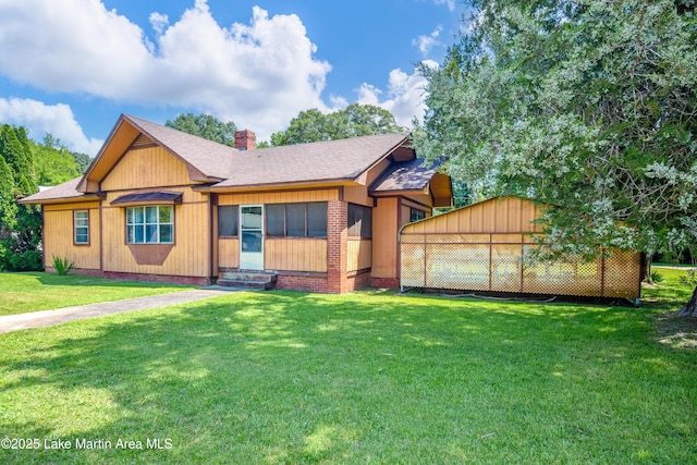 405 4th St, Tallassee, AL 36078 - view of front facade featuring a chimney, a front yard, a shingled roof, and entry steps