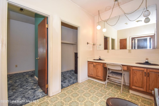 405 4th St, Tallassee, AL 36078 - bathroom with double vanity and baseboards
