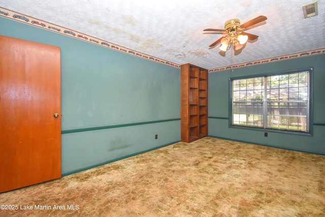 405 4th St, Tallassee, AL 36078 - spare room featuring ceiling fan, carpet floors, and a textured ceiling