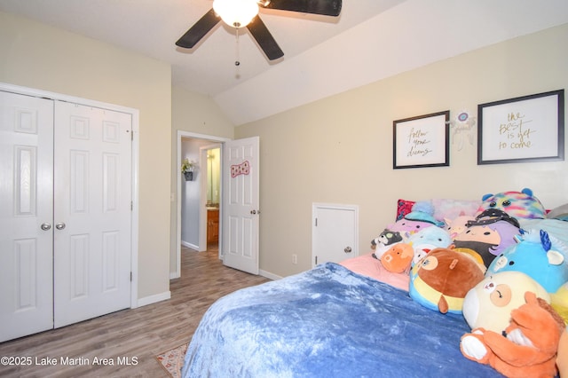 bedroom featuring lofted ceiling, hardwood / wood-style flooring, a closet, and ceiling fan