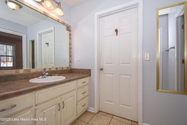 bathroom with tile patterned flooring and vanity