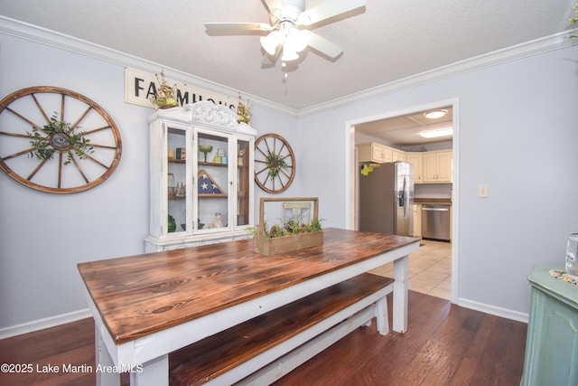 dining space featuring crown molding, hardwood / wood-style floors, and a textured ceiling