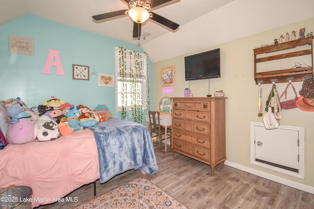 bedroom featuring vaulted ceiling, ceiling fan, and light hardwood / wood-style floors