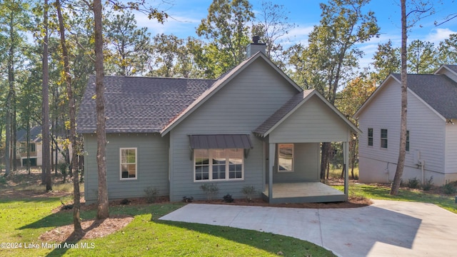 view of front of home with a patio area and a front lawn