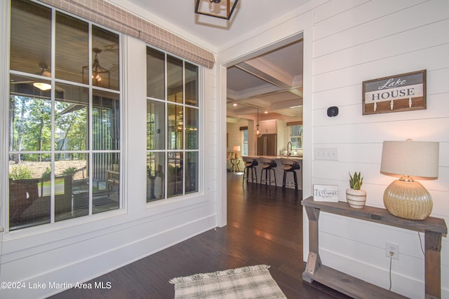 interior space featuring sink, coffered ceiling, dark hardwood / wood-style flooring, beamed ceiling, and wooden walls