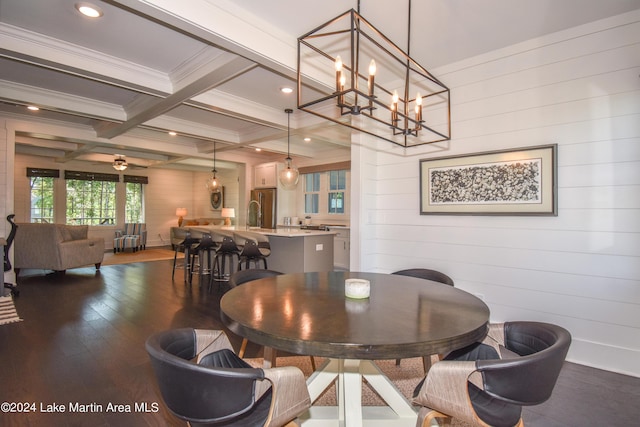 dining room with beam ceiling, ceiling fan with notable chandelier, dark hardwood / wood-style floors, and wooden walls