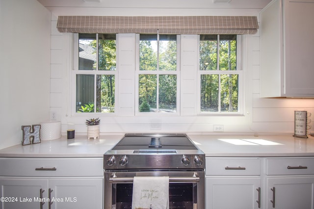 250 Old Jay Rd, Eclectic, AL 36024 - kitchen with electric range, light countertops, and white cabinets