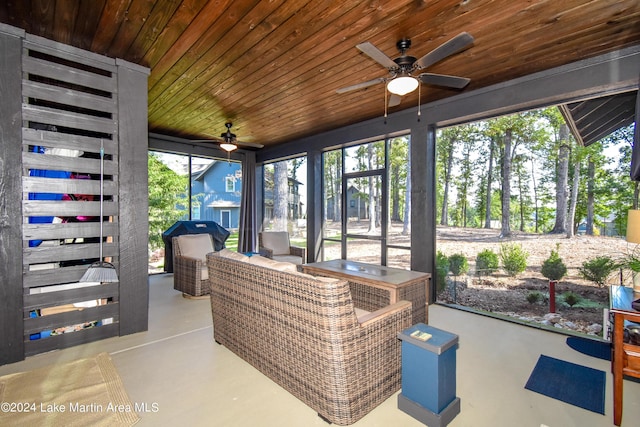 sunroom featuring a wealth of natural light, ceiling fan, and wood ceiling