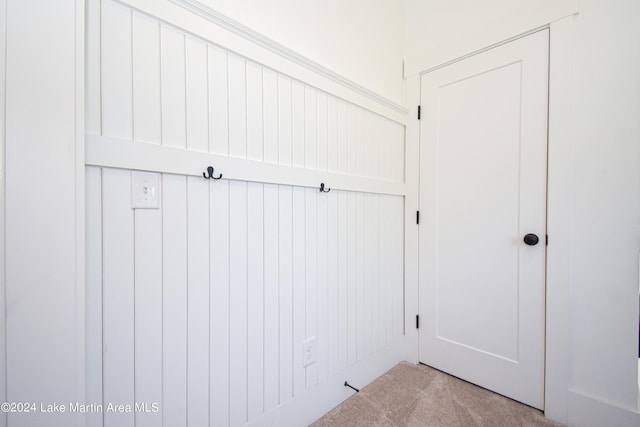 mudroom with light colored carpet