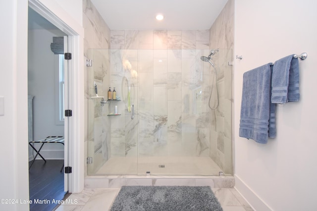 bathroom featuring a shower with shower door