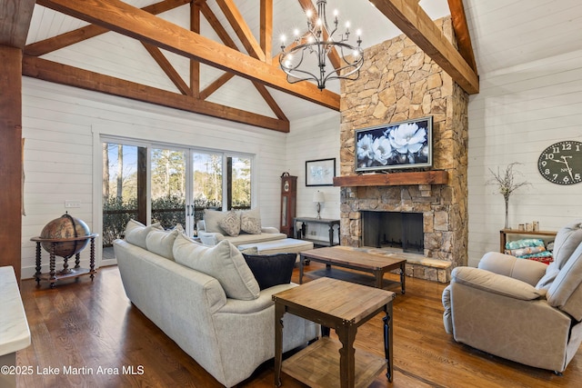 living room featuring dark wood-type flooring, beam ceiling, wooden walls, high vaulted ceiling, and a fireplace