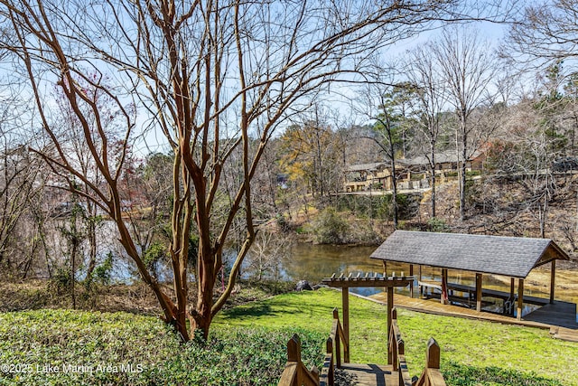 exterior space featuring boat lift, a boat dock, and a water view