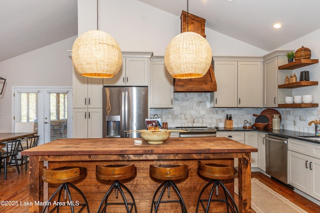 kitchen featuring dark wood-type flooring, open shelves, tasteful backsplash, appliances with stainless steel finishes, and butcher block counters