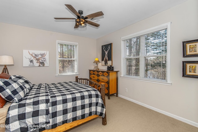 bedroom featuring a ceiling fan, baseboards, visible vents, and light carpet