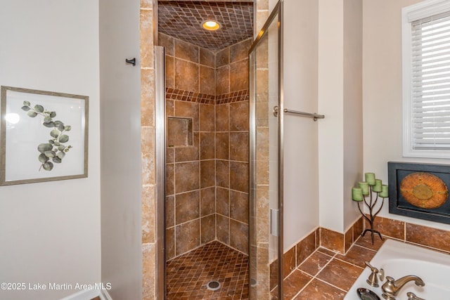 full bathroom featuring a garden tub and a shower stall