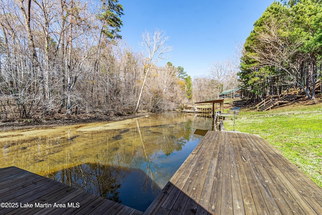 dock area with a yard and a water view