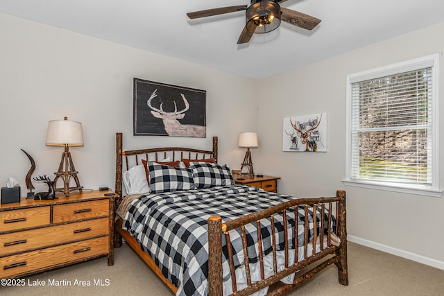 bedroom featuring baseboards, light carpet, and a ceiling fan