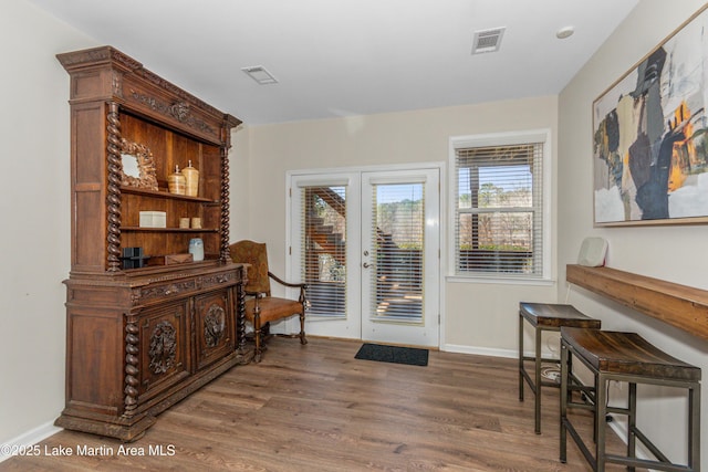 doorway to outside with visible vents, french doors, baseboards, and wood finished floors