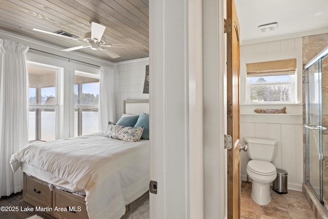 bedroom with visible vents, wood walls, wooden ceiling, and ornamental molding