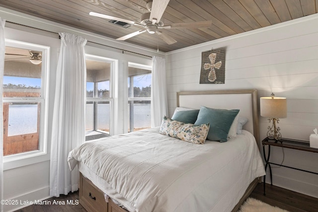 bedroom featuring wood finished floors, multiple windows, and wooden ceiling