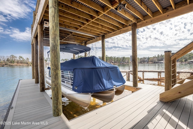 dock area with a water view and boat lift