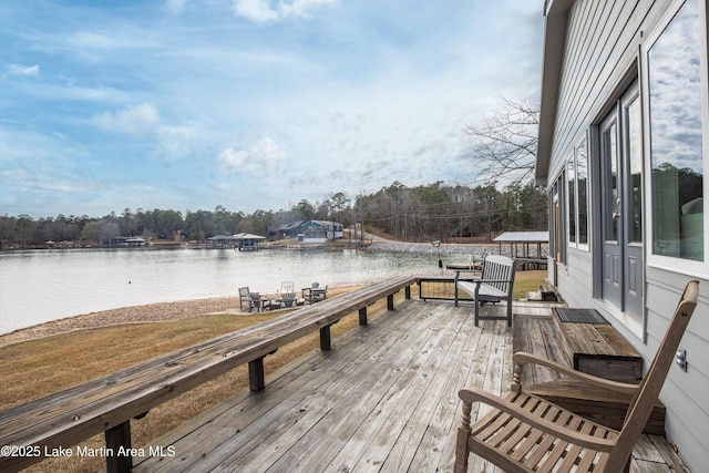 view of dock with a deck with water view