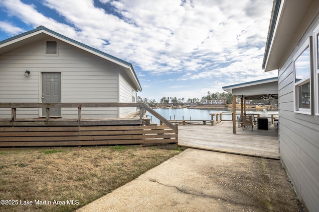 view of side of property featuring a deck with water view