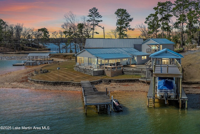 view of dock featuring a deck with water view and boat lift