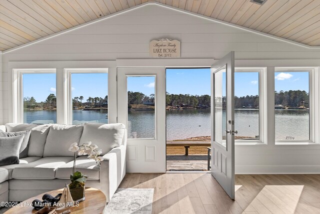 sunroom / solarium with a water view, wood ceiling, and vaulted ceiling