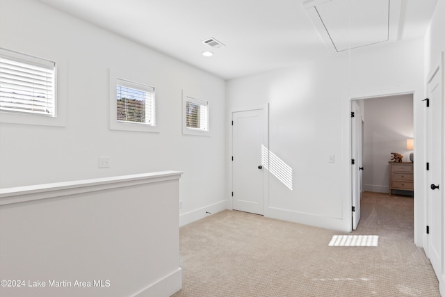 corridor with light colored carpet