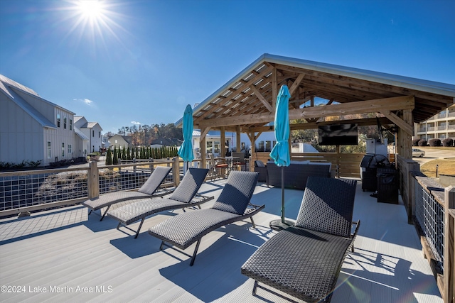 deck with a gazebo, an outdoor living space, and a grill