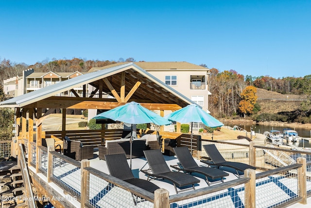 view of patio with outdoor lounge area and a water view