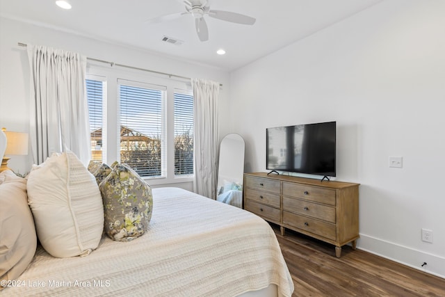 bedroom with ceiling fan and dark hardwood / wood-style floors