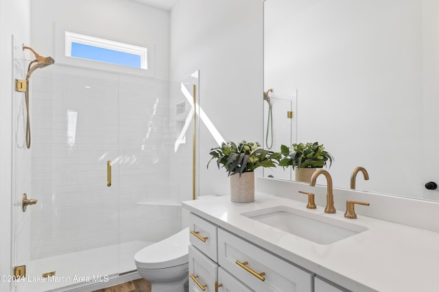 bathroom featuring hardwood / wood-style flooring, vanity, toilet, and walk in shower