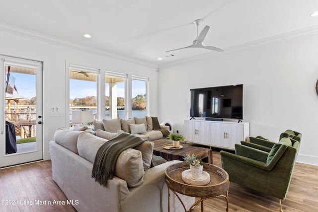 living room with ceiling fan, light hardwood / wood-style floors, and ornamental molding