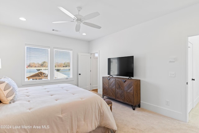 bedroom with ceiling fan and light colored carpet