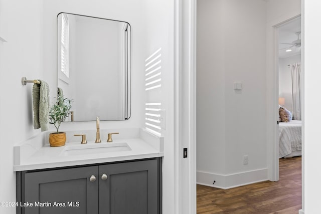 bathroom with ceiling fan, hardwood / wood-style floors, and vanity