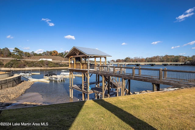 dock area featuring a lawn and a water view