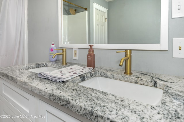 bathroom featuring a shower and vanity