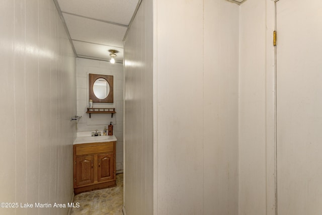 bathroom with wood walls and vanity