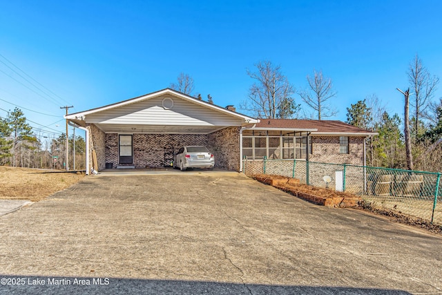 view of front of home featuring a sunroom and a carport