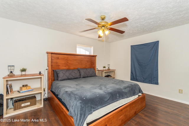 bedroom with a textured ceiling, ceiling fan, and dark hardwood / wood-style floors