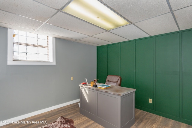 office space with dark hardwood / wood-style flooring and a drop ceiling